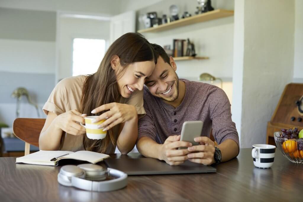 couple planning wedding with smartphone